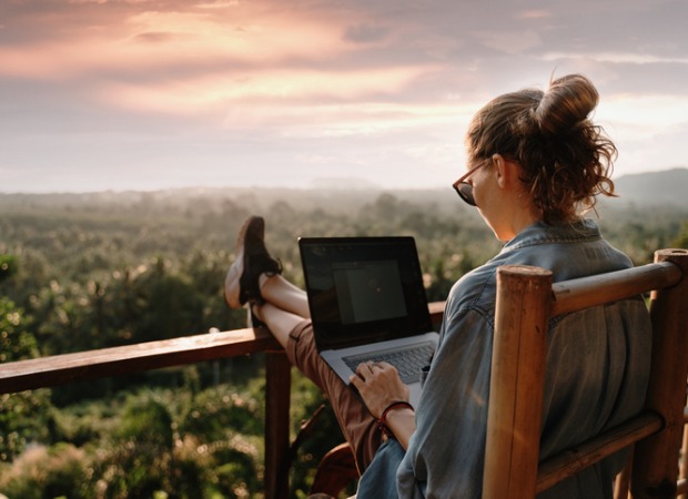 Woman working on her computer outside.